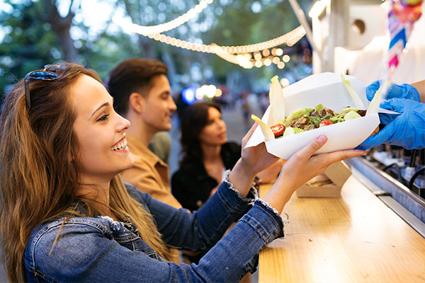 Frau kauft Essen am Foodtruck